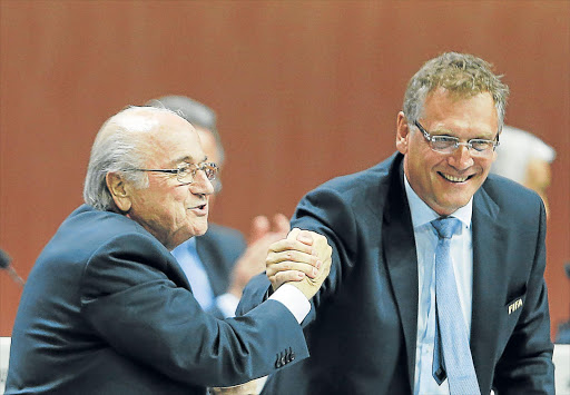 TRYING TIMES: Fifa president Sepp Blatter, left, and Jerome Valcke, secretary-general shake hands at the Fifa Congress in Zurich on Friday. Fifa denies media reports Valcke authorised $10-million (R122-million) in bank transactions that are central to the bribery investigation of the world soccer body Picture: REUTERS