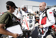 epa04549001 (FILE) A file photo dated 03 January 2015 shows Polish rider Michal Hernik (R) of KTM attending the technical review prior to the Rally Dakar 2015 in Buenos Aires, Argentina. The Dakar Rally runs from 03 to 17 January 2015. Reports on state that Michal Hernik died on 06 January 2015 while compiting in the third stage of the Rally, between San Juan and Chilecito, Argentina.  EPA/FELIPE TRUEBA