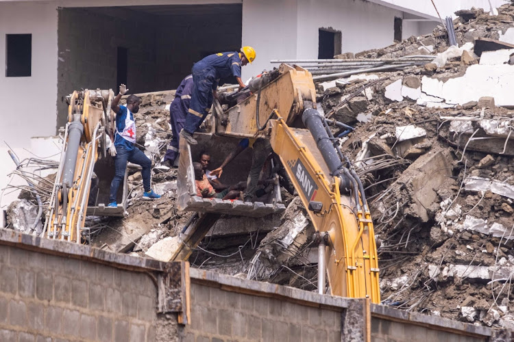 Rescue workers save a survivor that was trapped under the rubble of the collapsed 21-storey building in Ikoyi, Lagos, on November 2, 2021.