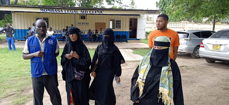 Francis Auma [L] and Salma Salim with Salim's relatives at Muhuri Legal Aid Clinic on Wednesday.