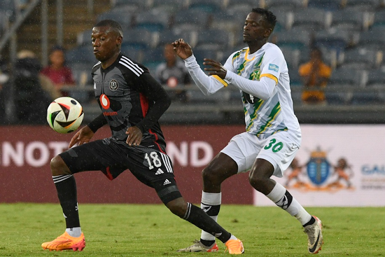 Kabelo Dlamini shields the ball away from Sbonelo Cele during their DStv Premiership match at Orlando Stadium.