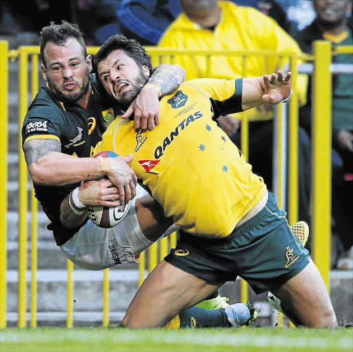 Springbok scrumhalf Francois Hougaard can't stop a determined Adam Ashley-Cooper of the Wallabies from scoring a try in yesterday's Rugby Championship match at Newlands .