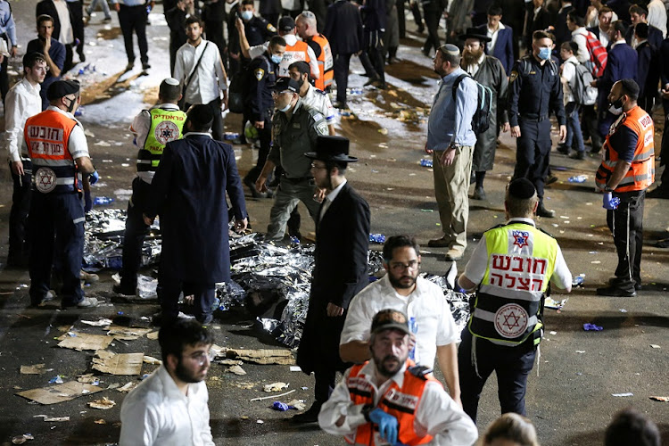 Medics and rescue workers attend to the deceased and wounded at the Lag B'Omer event in Mount Meron, northern Israel, on April 30, 2021, where fatalities were reported among the thousands of ultra-Orthodox Jews gathered at the tomb of a 2nd-century sage for annual commemorations that include all-night prayer and dance.