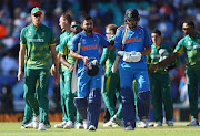 Virat Kohli and Yuvraj Singh of India in leave the field after India win the ICC Champions trophy cricket match between India and South Africa at The Oval in London on June 11, 2017  (Photo by Clive Rose/Getty Images)