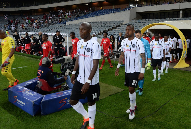 Players and officials walking to the field during the MTN 8, quarter final match Orlando Pirates and Highlands Park at Orlando Stadium on August 17, 2019 in Johannesburg, South Africa.