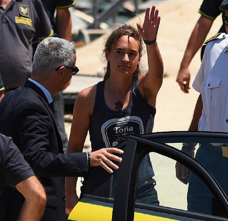 Carola Rackete, the 31-year-old Sea-Watch 3 captain, disembarks from a Finance police boat and is escorted to a car, in Porto Empedocle, Italy July 1, 2019 is in hiding.