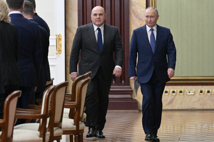Russian President Vladimir Putin and Prime Minister Mikhail Mishustin arrive for a meeting with members of the government in Moscow, Russia, on May 6 2024.