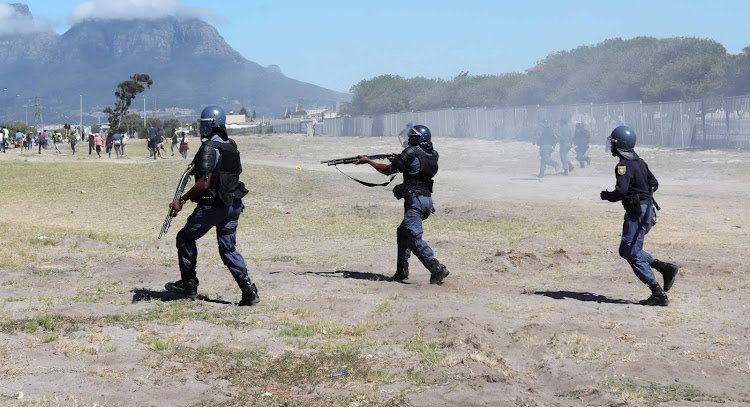 Police firing rubber bullets pursue protesting students at the Western Cape College of Nursing in Athlone, Cape Town, on February 12 2019.