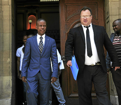 Pastor Paseka 'Mboro' Motsoeneng leaves the South Gauteng High Court in joy with his lawyer Andries Grove after he was awarded R100 000 for his wrongful arrest by police in 2011.