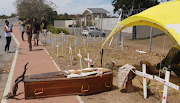 Christian Martin's coffin amid dozens of crosses outside the Eastern Cape government offices in Bhisho.