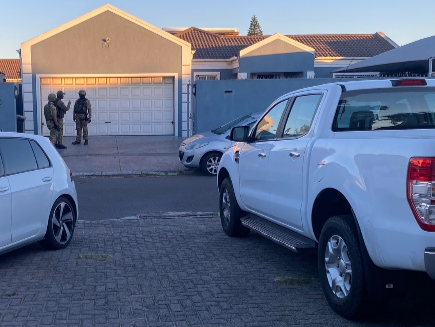 Special task force members at one of the properties raided in Parklands, Cape Town, on Tuesday.