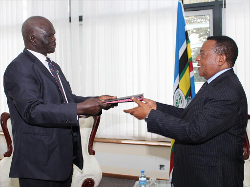 Chair of the EAC Council of Ministers, Amb. Dr. Augustine Mahiga receives document of instrument of ratification from Aggrey Tisa SabunI on South Sudan at the EAC headquarters, September 5, 2016 /ANGWENYI GICHANA