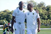 South Africa's Vernon Philander (R) with team mate Kagiso Rabada walk from the field after the national anthems during day one of the 1st International cricket test match between New Zealand and South Africa at the University Oval in Dunedin on March 8, 2017.
