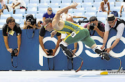 Oscar Pistorius is the centre of photographic attention as he flies out of his starting blocks in his 400m heat at the world athletics championships in Daegu, South Korea, yesterday. Pistorius finished third to qualify for today's semifinals Picture: KAI PFAFFENBACH/GALLO IMAGES