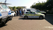 Police guard he van in which three security guards are kept after they were arrested this morning at the Thelle Mogoerane Hospital in Vosloorus.