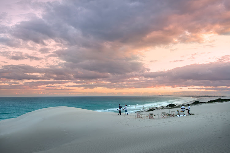 Morukuru Ocean House sundowners with sandboard.