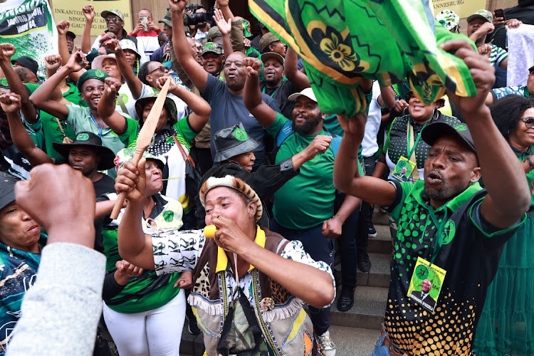 Members of MK Party celebrate outside the high court in Johannesburg yesterday after the Electoral Court ruled in favour of Jacob Zuma in his appeal against the decision by the IEC to disqualify him from the May 29 election.