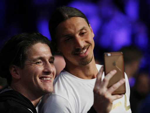 Manchester United's Zlatan Ibrahimovic with a fan ringside before the fight. Picture credits: Reuters