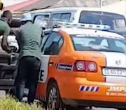 Johannesburg metro police are searching for a motorist who filmed two officers allegedly taking a bribe from two men in Bez Valley.