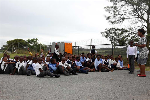 RAIN OR SHINE: Pupils from Nkwezana Primary School in Crossways near Chintsa are taught outside under a tree due to a shortage of classrooms. There are only six classrooms for the 680 Grade R to 7 pupils Picture:SIBONGILE NGALWA