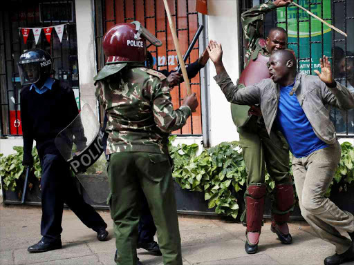 Kenyan policemen beat a protester during clashes in Nairobi, Kenya May 16, 2016. REUTERS/Goran Tomasevic