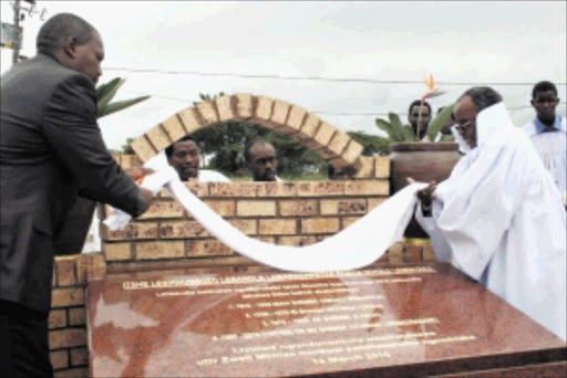 MOUNTAIN TOP: KwaZulu-Natal Premier Zweli Mkhize, left, with Inkosi Vimbeni Shembe of Ebuhleni, unveil the monument to mark 100 years of the existence of the Shembe religion. Despite much reference to the Old Testament and conventional Christian rituals, the Shembe's spiritual resonance is more African than Western. Every year followers make a pilgrimage to Mount Nhlangakazi. Pic: THULI DLAMINI. Circa March 2010. © Sowetan.