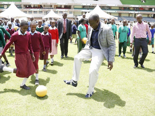 KICK IT: DP William Ruto plays with schoolchildren at Safaricom Stadium Kasarani during the launch of the Chevrolet One World Play Football project on February 12, 2016. Photo/DPPS