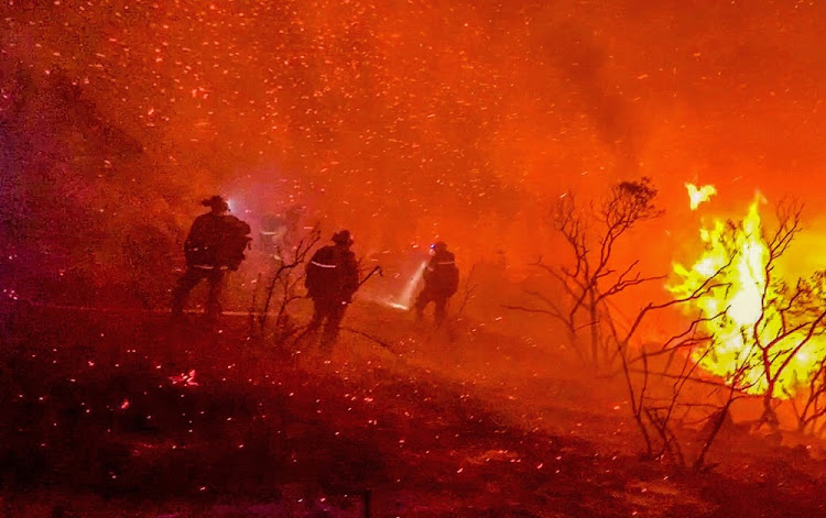 Firefighters work to extinguish a fire in Alpine, California, US, September 6, 2020, in this picture obtained from social media.