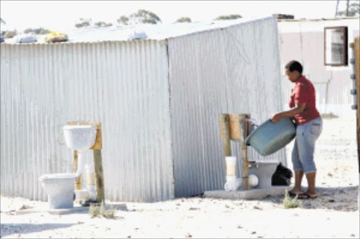 REMOVED: Residents of Makhaza section in Khayelitsha will now have to go back to sharing one toilet between five families after Cape Town city authorities removed the open air toilets yesterday. Pic. Esa Alexander.26/01/2010. © Sunday Times. Residents of Makhaza section in Khayelitsha have to cover themselves with blankets each time they make trips to the toilet because the toilets were built without walls.Picture: ESA ALEXANDER 26/01/2010 ------ f/c full size images pics