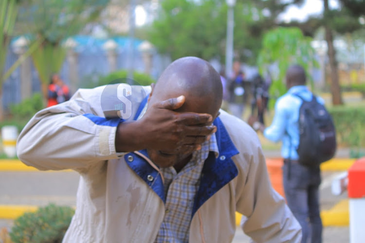 A protestor covering his eyes as police teargased Azimio supporters at KICC ahead of Azimio demonstrations on March 20, 2023