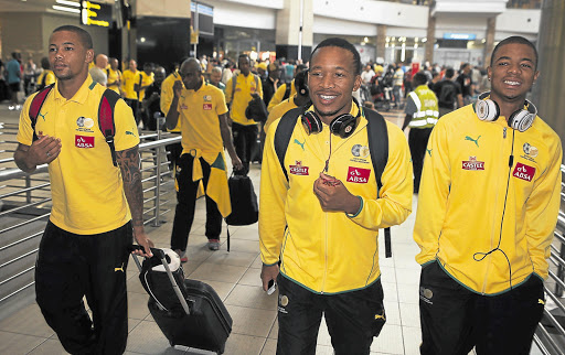 STILL FRESH: Lehlohonolo Majoro, left, and George Lebese arrive at OR Tambo airport from Equatorial Guinea after being benched for Friday's match Picture: RAYMOND PRESTON