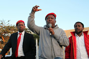 EFF president Julius Malema flanked by charipeson Dali Mpofu and spokesperson Mbuyiseni Ndlozii addressing EFF and community members in Alexander township about the scurge of Xenophophic attacks to foreign nationals. Picture Credit: Bafana Mahlangu.