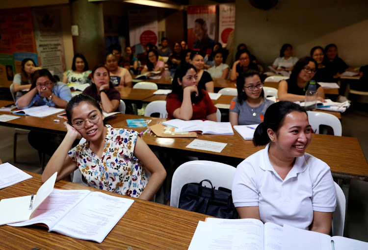Filipino workers, including nurses applying to work in United Kingdom, attend a lecture at a review center for the International English Language Testing System or IELTS in Manila, Philippines.
