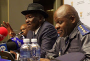 Police minister Bheki Cele and national police commissioner Khehla Sitole addresses the media at parliament in Cape Town during the annual SAPS crime statistic results. 