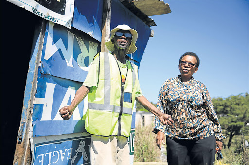 NEW DIMENSION OF NEIGHBOURLY: Peggy Mali, right, with Aaron Koti, whom she is assisting while his wife is in hospital after suffering a stroke. Mali is rebuilding their shack, and is also constructing six new toilets at the St George’s Presbyterian Church in East London Picture: MARK ANDREWS