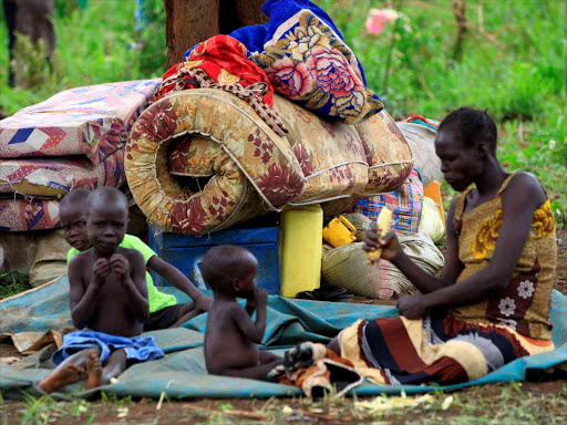An elderly woman displaced by fighting in South Sudan rests by her belongings in Lamwo after fleeing fighting in Pajok town across the border in northern Uganda, April 5, 2017. /REUTERS