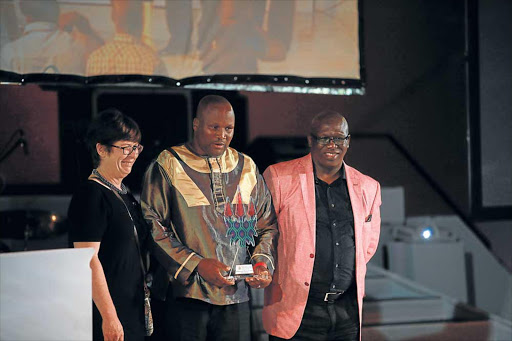 RECOGNITION: Daily Dispatch’s Lulamile Feni, centre, was crowned the best arts and culture journalist of the year over the weekend. He was presented the award by Dawn Barkhuizen from the Daily Dispatch and Phumzile Mnci from Umhlobo Wenene Picture: SINO MAJANGAZA