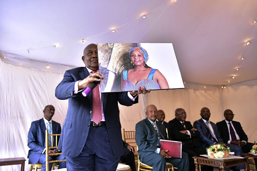 One of the delegates displays the picture of Andile's wife-to-be.