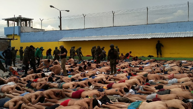 Inmates lie on the floor after Ecuador's police and armed forces freed prison staff members who had been held hostage by the prisoners in Ambato, Ecuador, in this handout picture made available on January 13 2024.