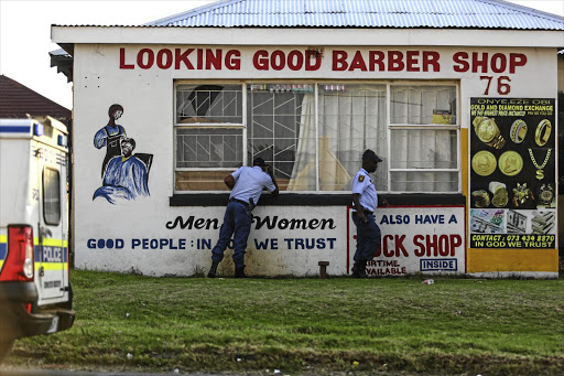 Police look for clues outside the premises where five teenage girls were found. A man and a 17-year-old girl are believed to be responsible. The man was arrested and faces charges of human trafficking.