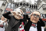 Protesters demonstrate outside the London High Court as James Murdoch appears before the Leveson inquiry Picture: GALLO IMAGES