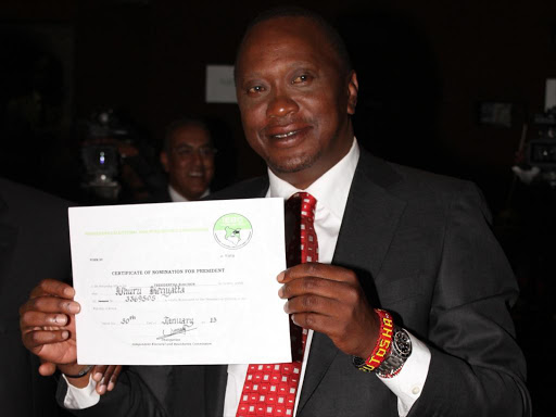 A file photo of President Uhuru Kenyatta receiving his nomination certificate from IEBC when he was cleared to run in the 2013 general elections. /JACK OWUOR