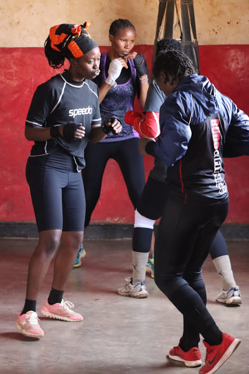 Hit Squad boxers, Emily Juma (L) and Amina Martha spar during a training session at the Mathare Depot.