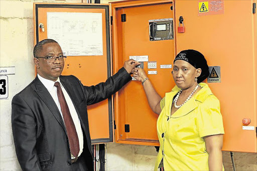 SUN POWER: Eskom general manager for the Eastern Cape Sifiso Mazibuko and senior general manager Ayanda Nakedi switch on the solar panels at the Sunilaws Office Park in Beacon Bay Picture: STEPHANIE LLOYD