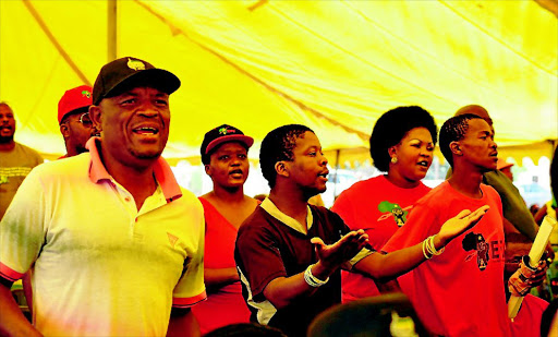 PRAISE SONGS: Friends and members of political parties including EFF sing and dance during the memorial service of slain businessman Wandile Bozwana at Montshioa Stadium in Mahikeng, North West, yesterday Photo: Tiro Ramatlhatse