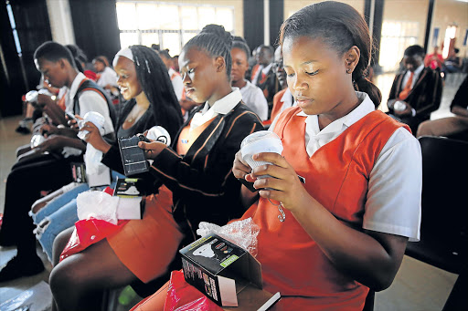 ALL SMILES: Mahindra SA and Rotary Club SA donated solar lamps and books to Gonubie High pupils yesterday Picture: MARK ANDREWS