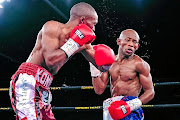 Simpiwe Konkco punches  Siyabonga Siyo in a previous  IBO strawweight  title bout.  / Alex van der Westhuizen