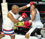 TRADING BLOWS: Ndobayini Kholose of North West, right, in a battle against Phindile Mwelase of KwaZulu-Natal, during their junior featherweight fight in Mpumalanga in April. Mwelase died in hospital on Saturday after being knocked out earlier this month