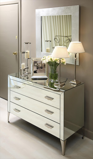 Mirrored furniture and metallic accessories are a must for a glam decor scheme.