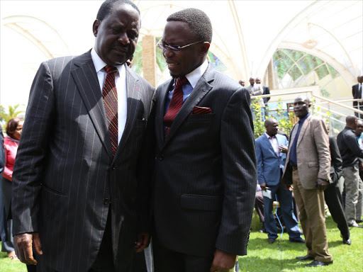 Cord leader Raila Odinga and Ababu Namwamba chat after a parliamentary group meeting at the Boma Hotel on July 22 last year/HEZRON NJOROGE